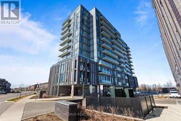 Brampton (Northwest Brampton) condo for rent - A modern multi-story building with a glass facade is under construction.