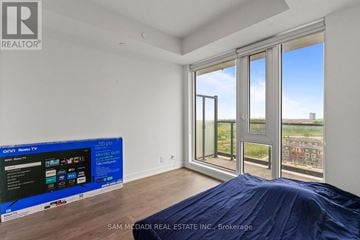 Brampton (Northwest Brampton) condo for rent - A bedroom with a large bed and a flat screen TV.