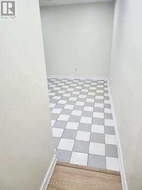 Toronto (Centennial Scarborough) apartment for rent - A hallway with a checkered floor and white walls.