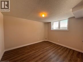 New Dundee apartment for rent - A room with wooden flooring and a window with blinds.