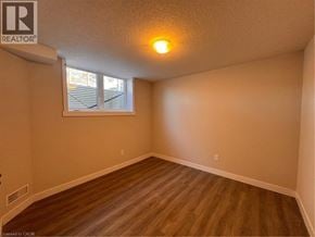 New Dundee apartment for rent - A room with a window and wooden flooring.