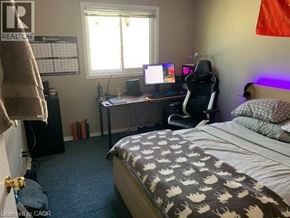 Waterloo apartment for rent - A bedroom with a bed, desk, and chair.
