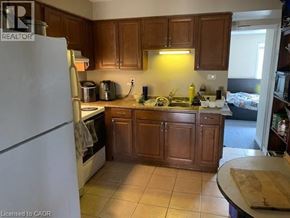Waterloo apartment for rent - A kitchen with wooden cabinets and a white refrigerator.