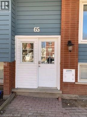Waterloo apartment for rent - A white door with a glass window is on the front of a blue house.