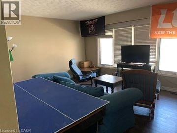 Waterloo apartment for rent - A living room with a blue table and a TV on the wall.