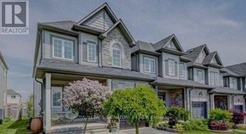 Clarington (Bowmanville) apartment for rent - A large, multi-level house with a well-manicured front yard.