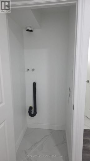 Clarington (Bowmanville) apartment for rent - A white door with a black handle and a black pipe.