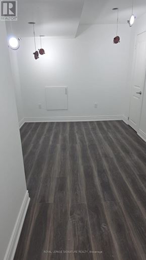 Clarington (Bowmanville) apartment for rent - A room with wooden floors and white walls.