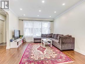 Richmond Hill (Crosby) apartment for rent - A living room with a grey couch, a white coffee table, and a red rug.