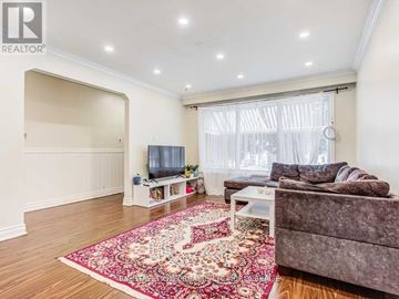 Richmond Hill (Crosby) apartment for rent - A living room with a grey couch and a red rug.
