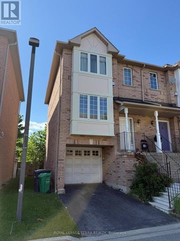 Mississauga (Hurontario) townhouse for rent - A two-story brick house with a garage and a driveway.