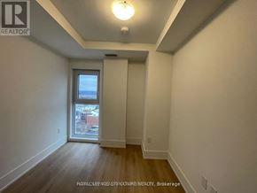 Hamilton (Central) condo for rent - A room with a slanted ceiling and a window.