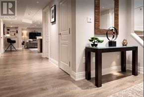 Hamilton (Waterdown) apartment for rent - A well-lit hallway with a table and a mirror on the wall.