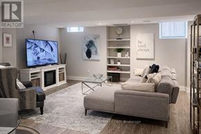 Hamilton (Waterdown) apartment for rent - A living room with a grey couch, a television, and a coffee table.