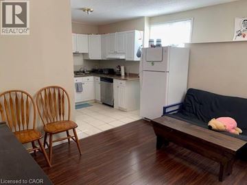 Waterloo apartment for rent - A kitchen with white cabinets and a refrigerator.