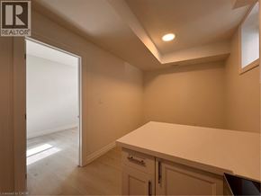 Kitchener apartment for rent - A room with a white countertop and cabinets with a doorway leading to another room.