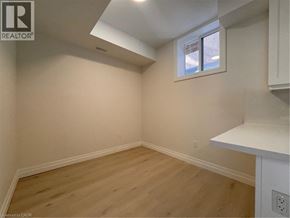 Kitchener apartment for rent - A room with a window and wooden flooring.