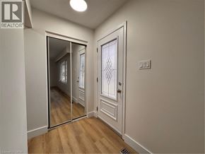 Kitchener apartment for rent - A hallway with a mirrored door and a white door.