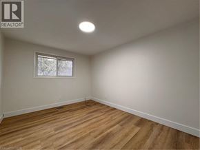 Kitchener apartment for rent - A room with wooden flooring and a window.