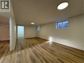Kitchener apartment for rent - A room with wooden flooring and a window with blinds.