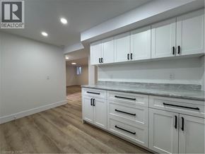 Kitchener apartment for rent - A kitchen with white cabinets and a marble countertop.
