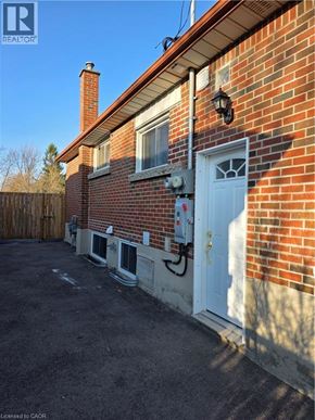 Hamilton apartment for rent - A red brick house with a white door and windows.