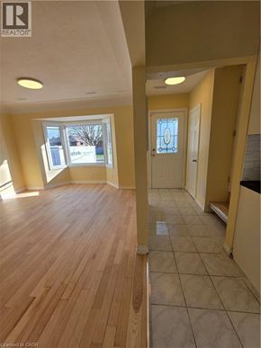 Hamilton apartment for rent - A room with wooden floors and a doorway leading to another room.