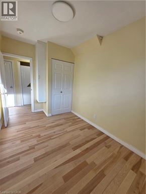 Hamilton apartment for rent - A room with wood flooring and white walls.