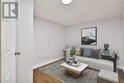 Toronto (Birchcliffe-Cliffside) apartment for rent - A living room with a couch, coffee table, and a painting on the wall.