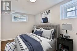 Toronto (Birchcliffe-Cliffside) apartment for rent - A bedroom with a bed, nightstand, and lamp.