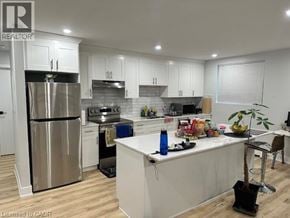 Kitchener apartment for rent - A kitchen with a refrigerator, oven, and sink.