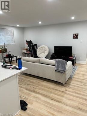 Kitchener apartment for rent - A living room with a white couch and a black chair.