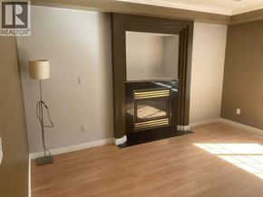 Coquitlam apartment for rent - A living room with a fireplace and a lamp.