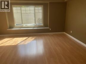 Coquitlam apartment for rent - A room with a window and wooden flooring.
