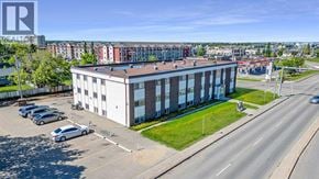Grande Prairie apartment for rent - A large building with a parking lot in front of it.