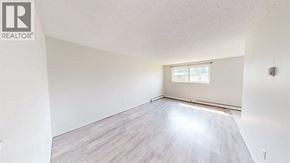 Grande Prairie apartment for rent - A room with a window and wooden flooring.