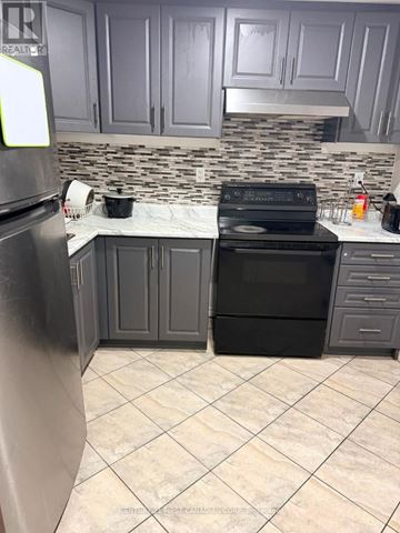 London East (East A) apartment for rent - A kitchen with a black stove and refrigerator.