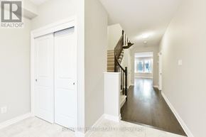 Ottawa apartment for rent - A hallway with a staircase and a door.