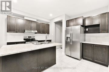 Ottawa apartment for rent - A modern kitchen with dark brown cabinets and a marble countertop.