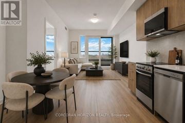 Toronto (Rouge) condo for rent - A modern kitchen with stainless steel appliances and a dining table with chairs.