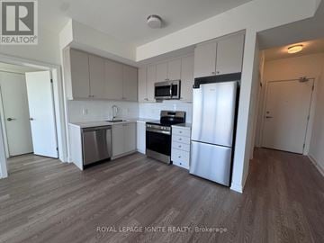 Clarington (Bowmanville) condo for rent - A kitchen with white cabinets and stainless steel appliances.