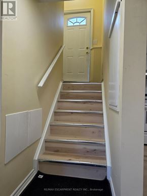 Hamilton (Bonnington) apartment for rent - A white door is at the end of a hallway.