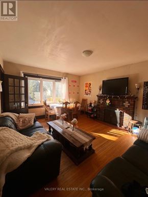 Kingston (Central City East) apartment for rent - A living room with a couch, a coffee table, and a television.
