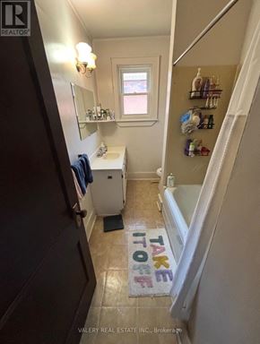 Kingston (Central City East) apartment for rent - A bathroom with a towel hanging on the door and a window.