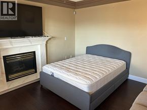 Burnaby apartment for rent - A bed with a mattress in a room with a fireplace.