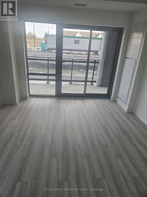 Clarington (Bowmanville) condo for rent - A room with a sliding glass door leading to a balcony.