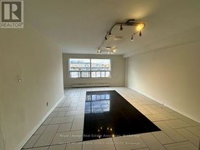 Mississauga (Cooksville) apartment for rent - A room with a large window and a black floor mat.