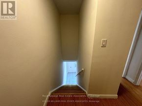 Mississauga (Cooksville) apartment for rent - A hallway with a staircase leading to a door at the end.