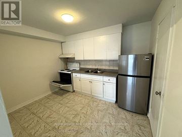 Mississauga (Cooksville) apartment for rent - A kitchen with white cabinets and a stainless steel refrigerator.