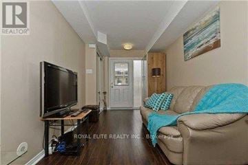 Mississauga (Churchill Meadows) townhouse for rent - A living room with a couch, television, and a painting on the wall.